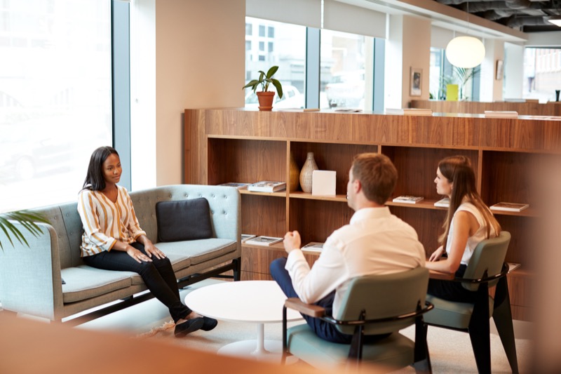 Colleagues mentoring one another in a relaxed office setting